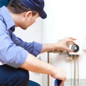 Plumber repairing a hot water heater